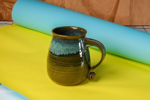 Handcrafted ceramic mug with unique glaze and rustic charm, perfect for coffee or tea
